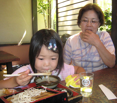 Little girl eating soba 